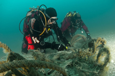 Divers collecting fishing nets